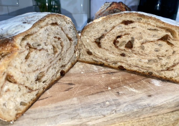 Cross-section of a seeded sourdough loaf showing open crumb
